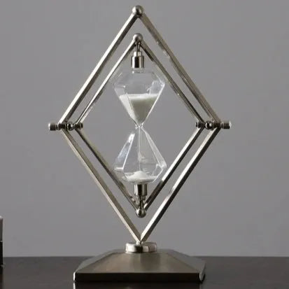 Glass sand timer with zinc alloy metal ornaments in bronze or silver colours, showing sand flow for timing.