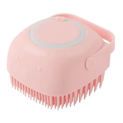 Blue silicone dog bath and massage brush held in a hand.