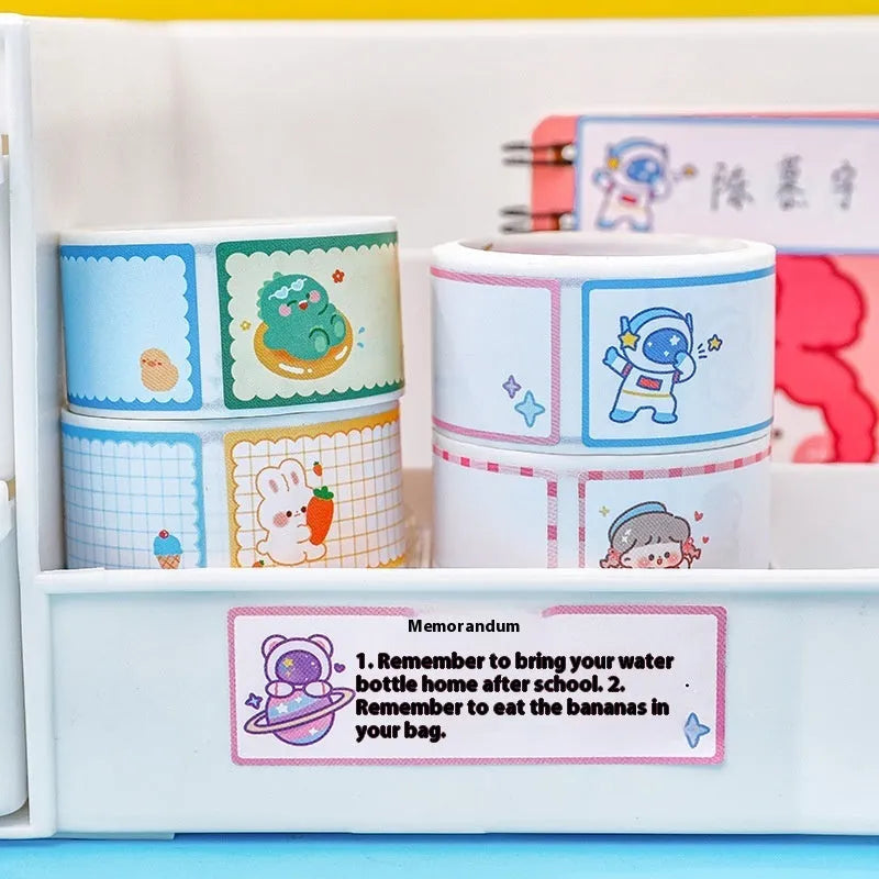 Roll of student name tape stickers with cartoon dinosaur, astronaut, rabbit, and girl designs for labelling