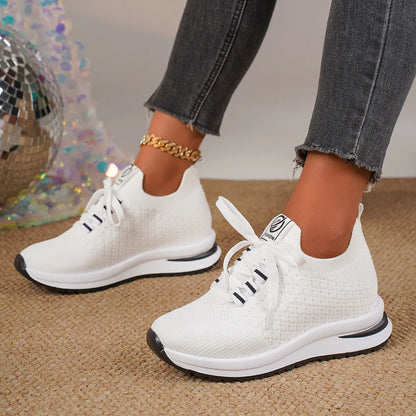 Women's black mesh lace-up platform sneakers with a round toe and flat rubber sole on a white background.