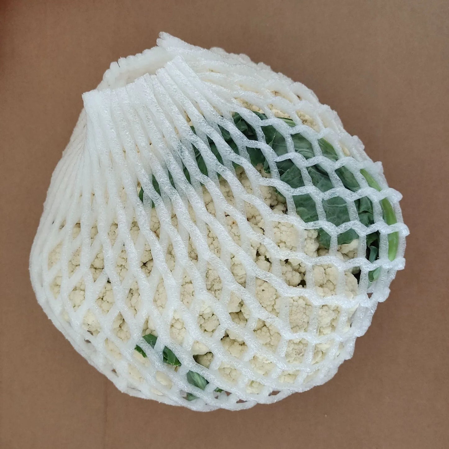 A white foam protective net sleeve stretched open, showing its simple tubular construction.