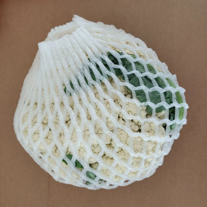 A white foam protective net sleeve stretched open, showing its simple tubular construction.