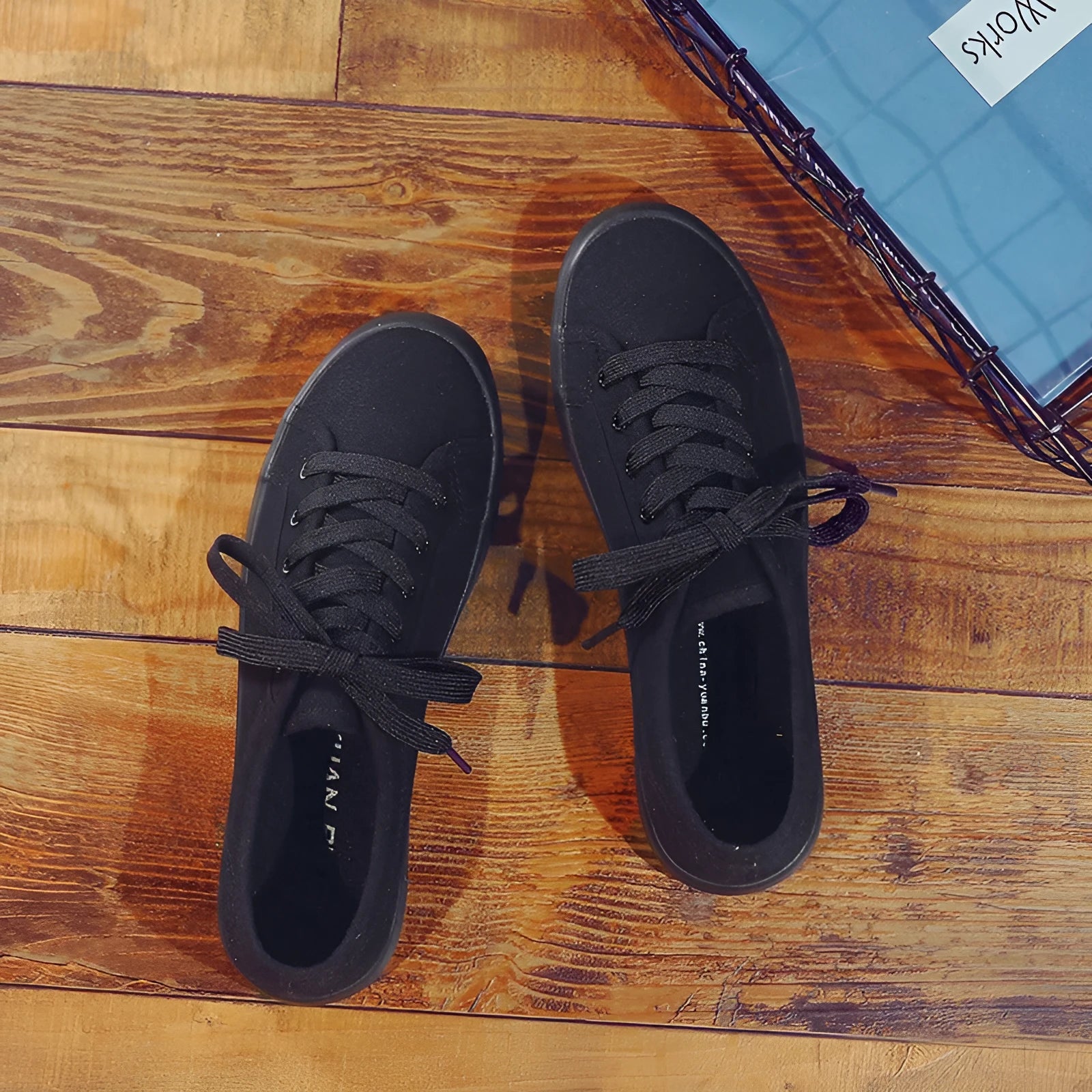 All-black women's canvas work shoes with flat rubber soles and lace-up front
