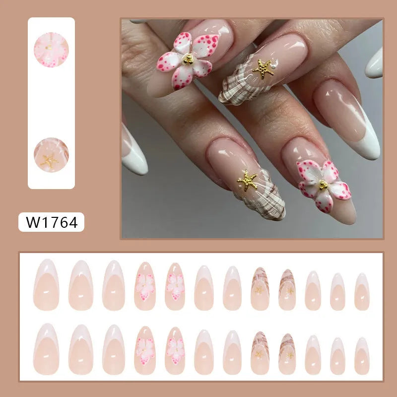 Set of floral French tip false nails with grey rock pattern accents on a simple pink base.