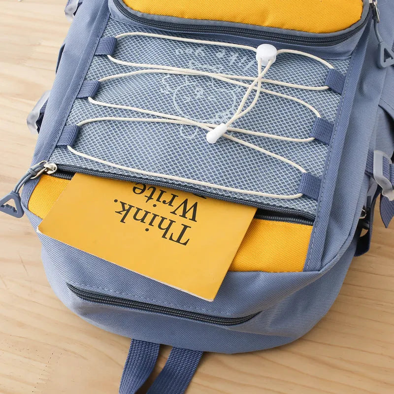 Nylon junior high school backpack in solid colour with curved shoulder straps and organisational compartments