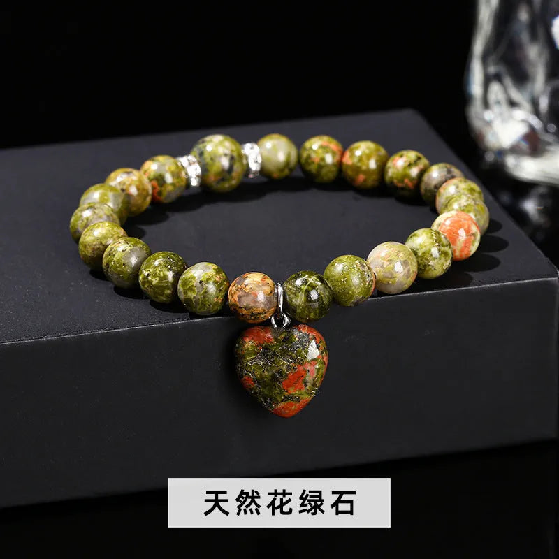 Handmade women's bracelet with natural gemstone beads and a silver love pendant charm.