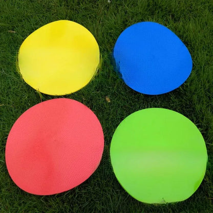 Soft yellow TPE football landmark pad disc on grass, 23 cm diameter.