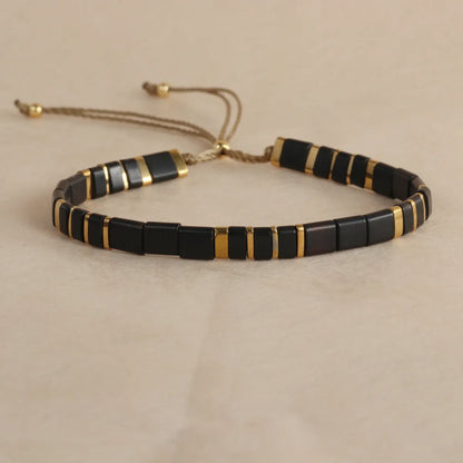 Adjustable pull beads glass bracelet in geometric shapes, shown in milky white colour.