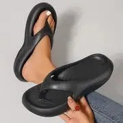 Women's black thick-soled EVA flip-flops with a non-slip pattern on the sole.