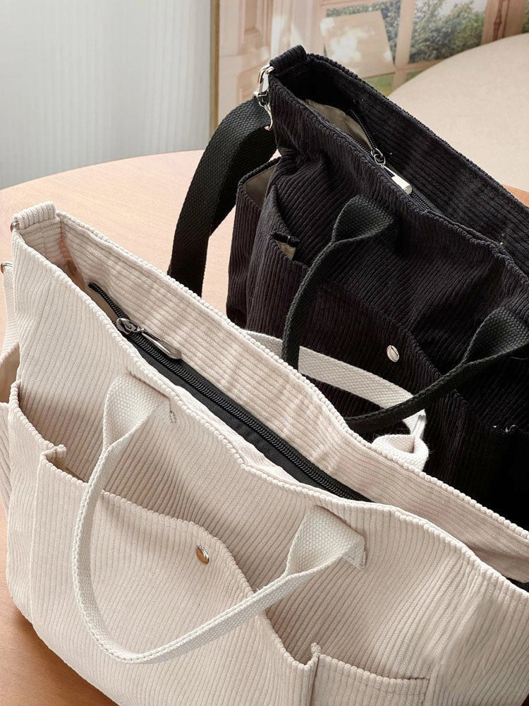 Adjustable corduroy messenger bag in various colors with zippered pocket