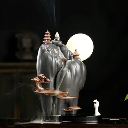 Purple sand tea pet backflow fragrance ornament with LED lighting creating cascading smoke effect