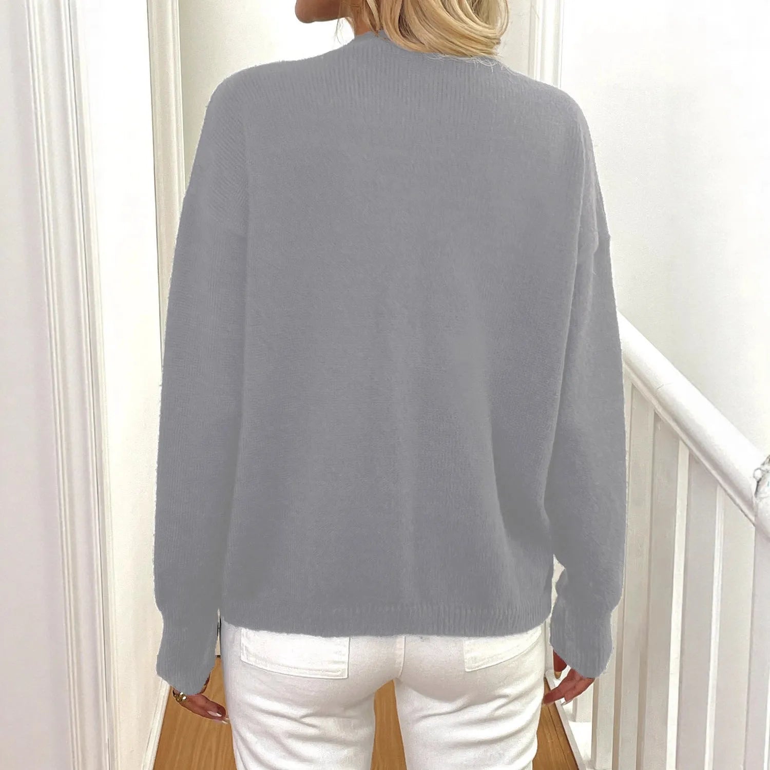 Women's grey deer plush long sleeve sweater coat with princess sleeves on a hanger.
