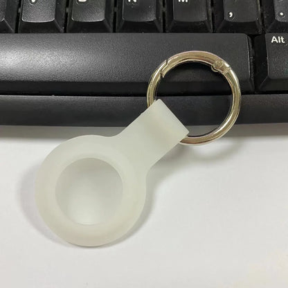 Black waterproof silicone Airtag protective case with metal keychain clip, shown next to colour options.