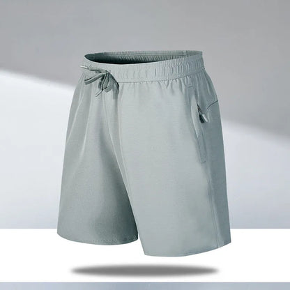 Man wearing black loose-fit ice silk sports shorts with a micro-elastic waistband, suitable for running or casual summer wear.
