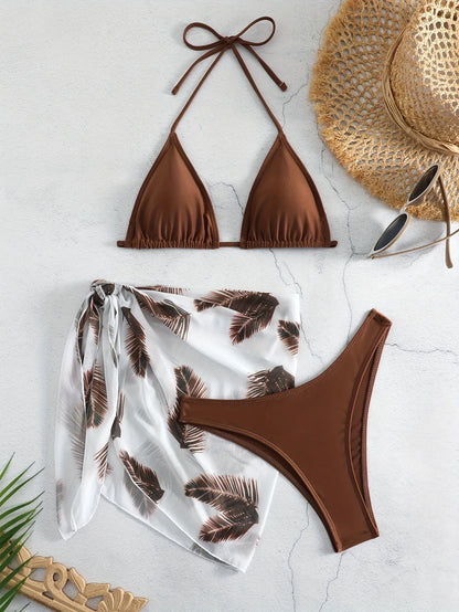 Women's orange three-piece bikini swimsuit with a matching printed gauze skirt laid flat.