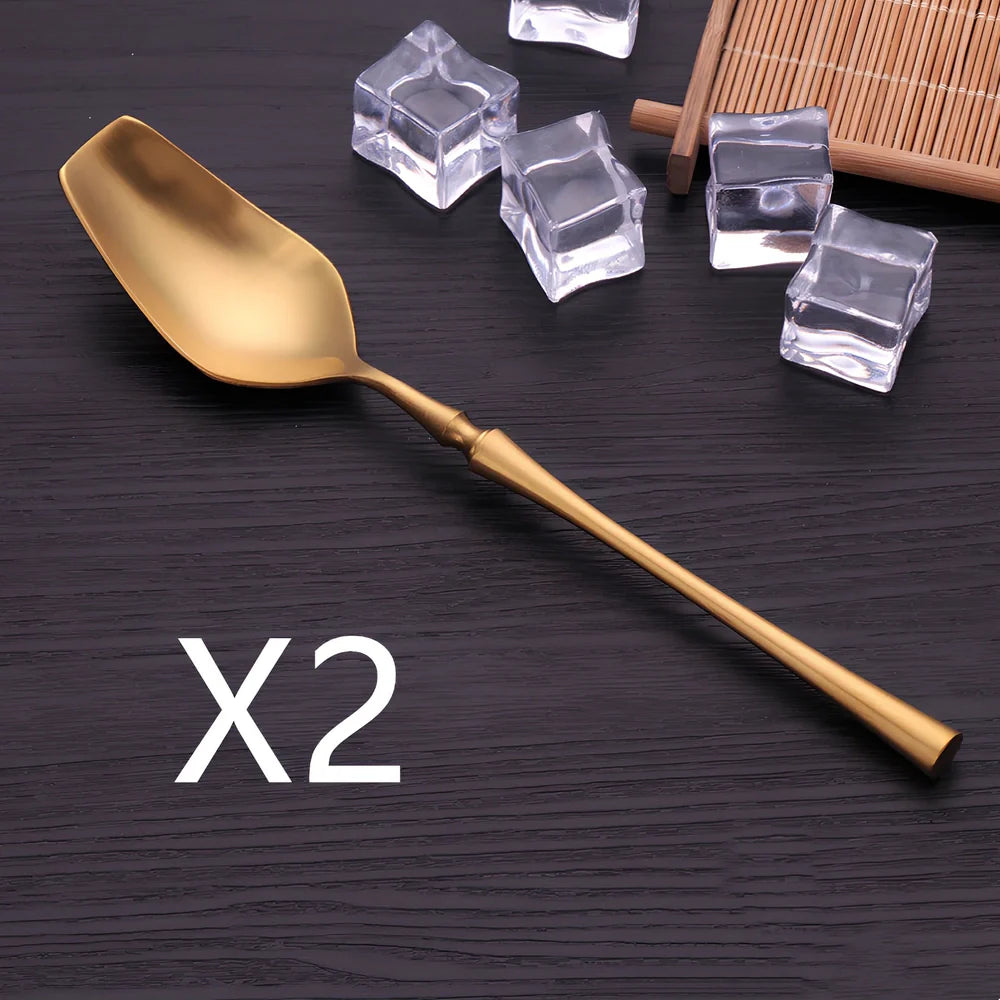 Four-piece stainless steel cutlery set showing main knife, fork, spoon, and teaspoon with mirror finish