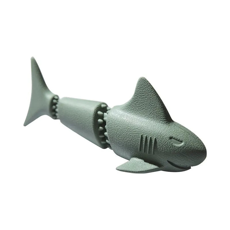 Blue rubber shark-shaped dog toy with food dispensing openings on a white background.