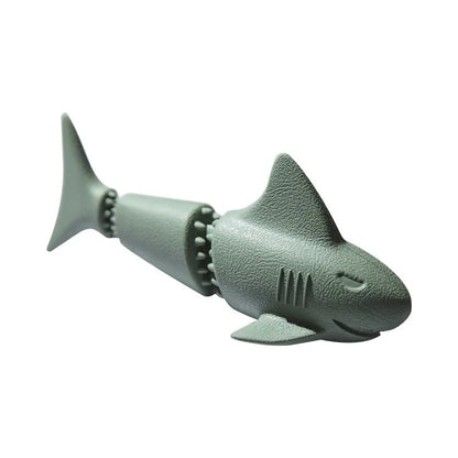 Blue rubber shark-shaped dog toy with food dispensing openings on a white background.