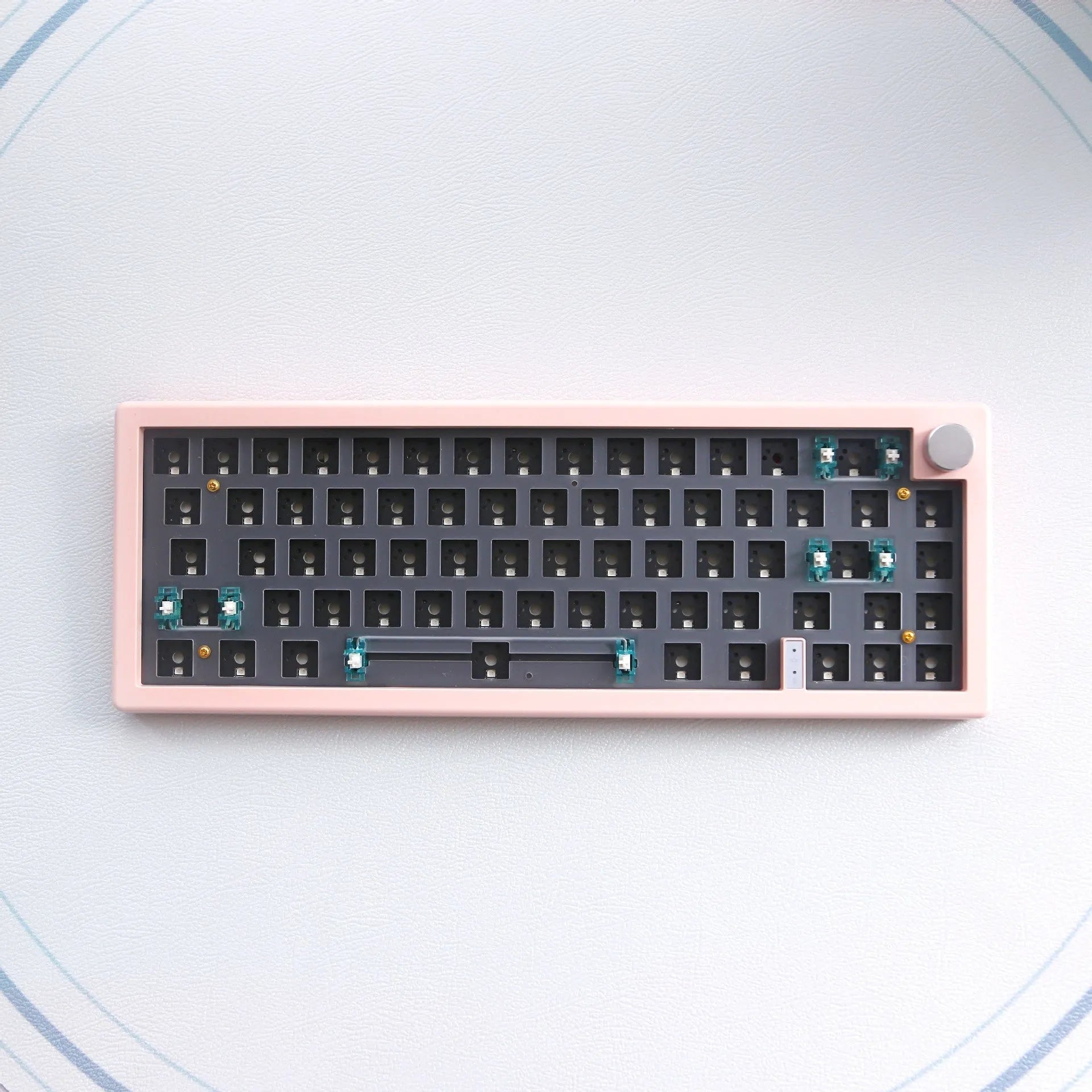 Customisable DIY mechanical keyboard kit with RGB backlighting and control knob, shown in multiple colour options