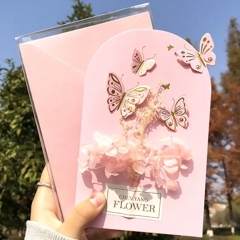 Handmade 3D pop-up greeting card with butterfly shape showing artificial flowers and hot stamping details