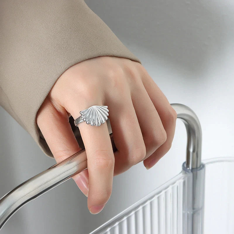 Elegant scallop-inspired titanium steel ring in steel or gold finish, available in sizes 6, 7, and 8, featuring a unique geometric design for a stylish and versatile accessory.