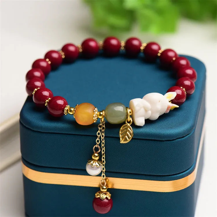Natural cinnabar rabbit bracelet in beeswax purple and gold sand, national style, shown in 8mm and 10mm sizes.