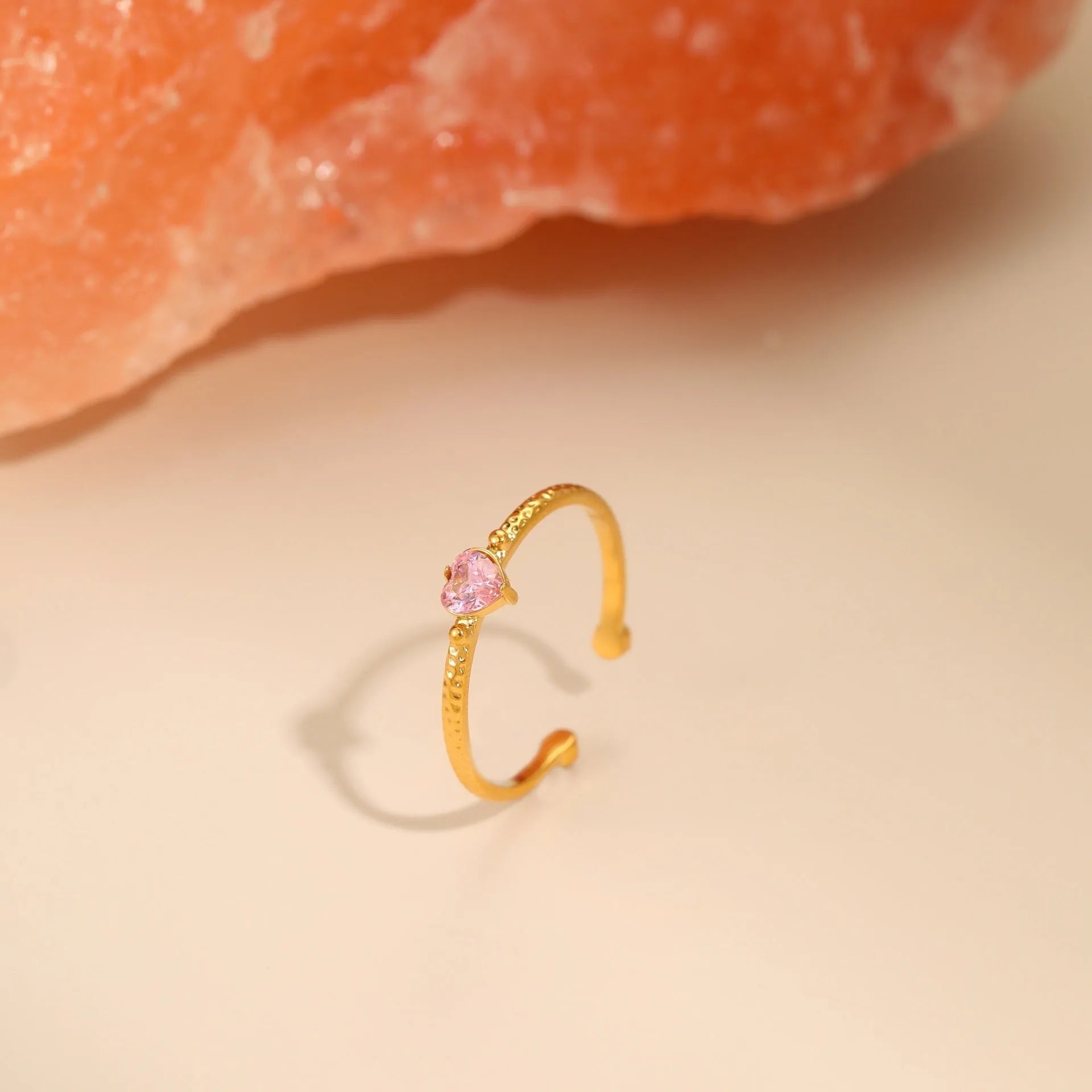 Open-ended stainless steel ring with geometric love heart shape and inlaid green zircon stone.