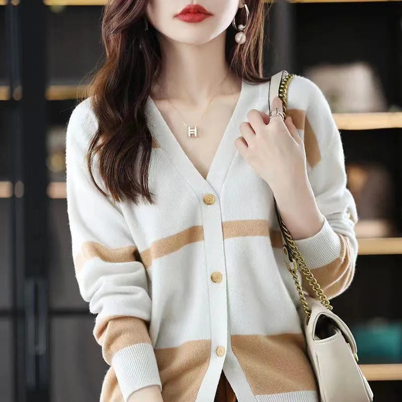 Women's black and white striped V-neck cardigan with buttons, showing a textured 3D knit pattern.