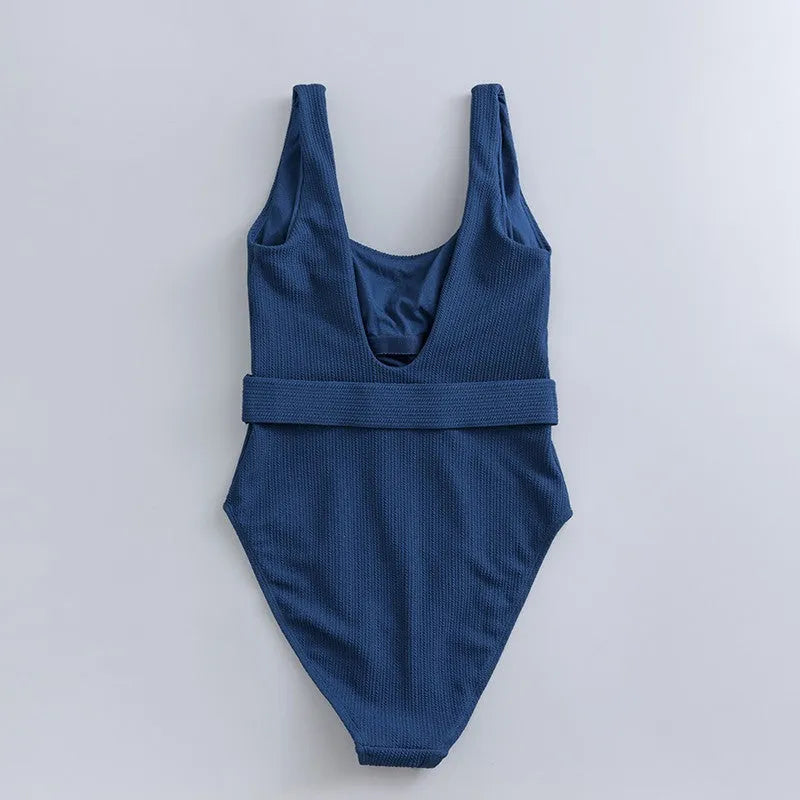 Navy blue women's one-piece swimsuit with triangle top and built-in chest pads for swimming