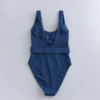 Navy blue women's one-piece swimsuit with triangle top and built-in chest pads for swimming