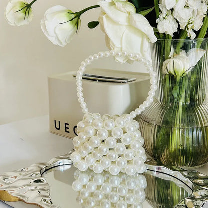 Women's imitation pearl mini crossbody handbag with geometric pattern in a pearl colour.