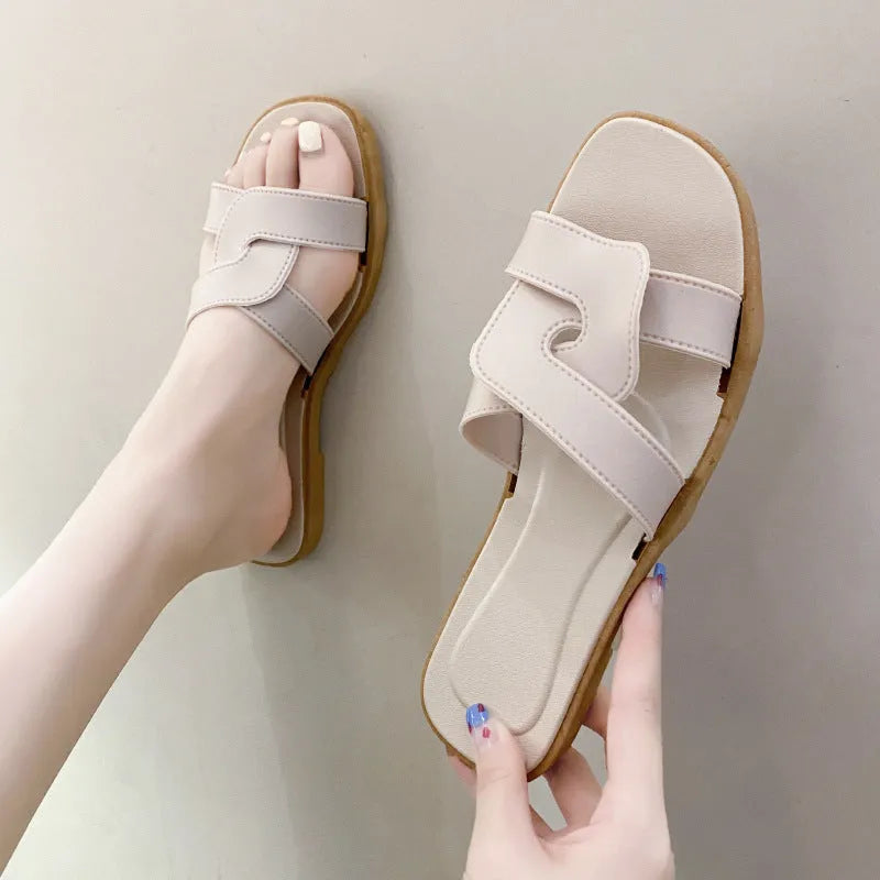 Women's PVC toe ring slippers with a cross strap in milky white, shown from a side angle.