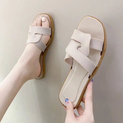Women's PVC toe ring slippers with a cross strap in milky white, shown from a side angle.