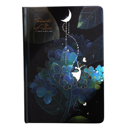 A5 notebook with luminous cover in Deep Blue, open to show 100 gsm paper and colour illustrations