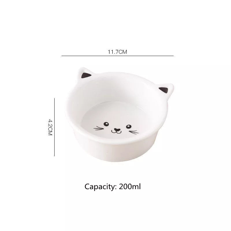 Ceramic pet food bowl with cat face design, easy to clean porcelain material