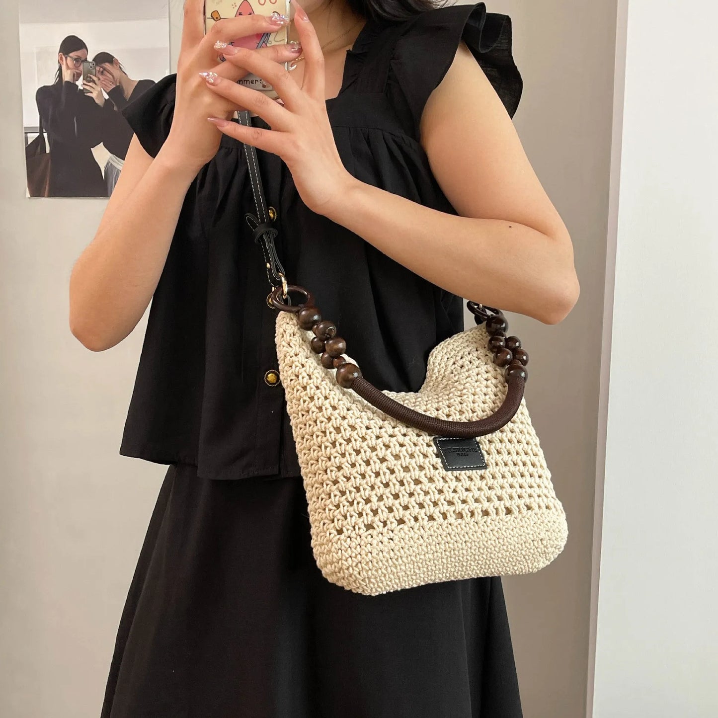 Large brown knitted bucket tote beach bag with contrast stitching and a zip internal compartment.