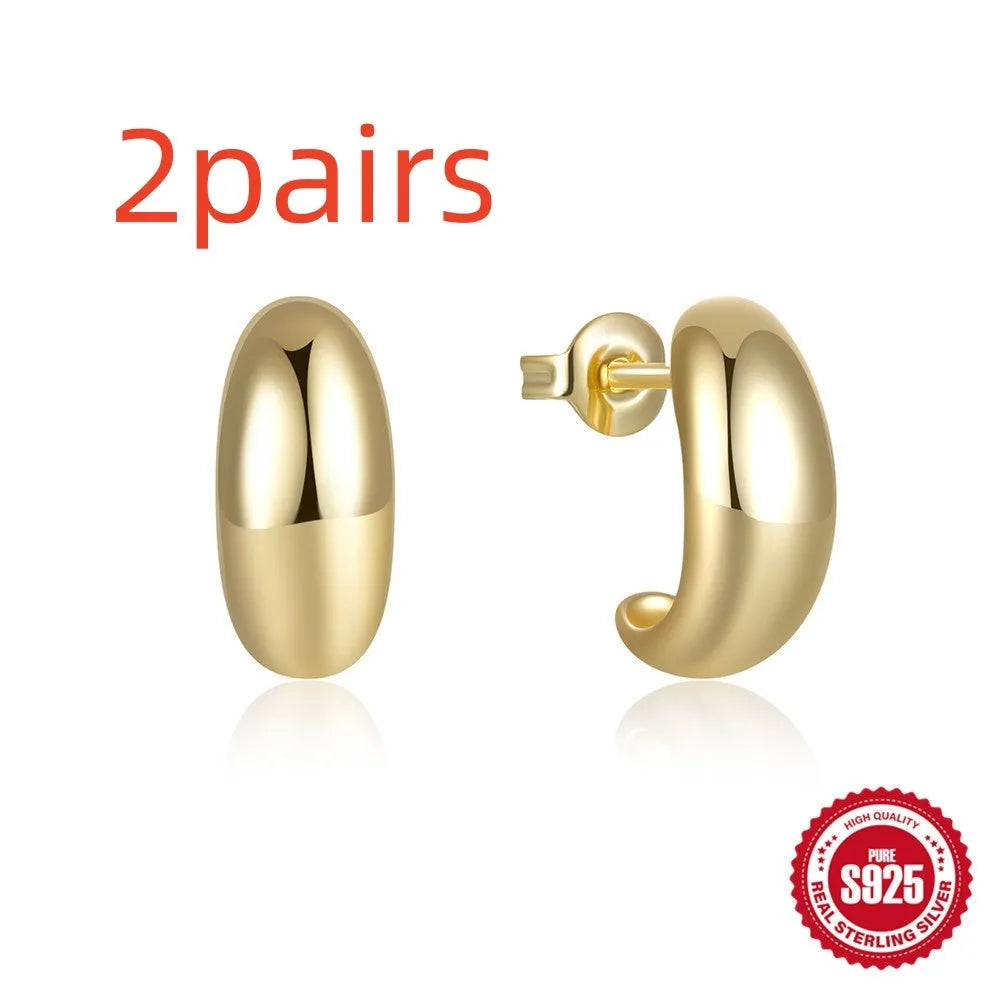 C-shaped sterling silver earrings with glossy electroplated finish in gold or white gold options
