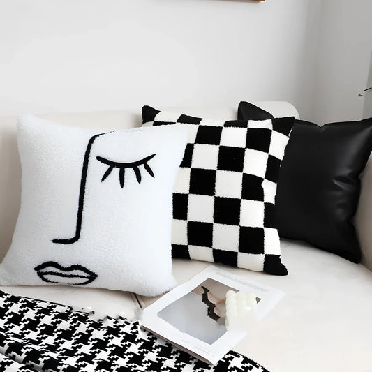 Black and white checkerboard square pillow measuring 45cm on sofa