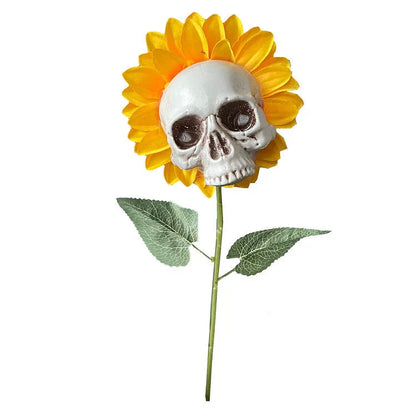 A group of skull-shaped sunflower ornaments arranged in a Halloween-themed outdoor display