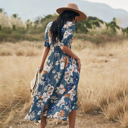 Yellow floral print women's dress with V-neck, short sleeves, elastic waist, and a large hemline midi skirt.