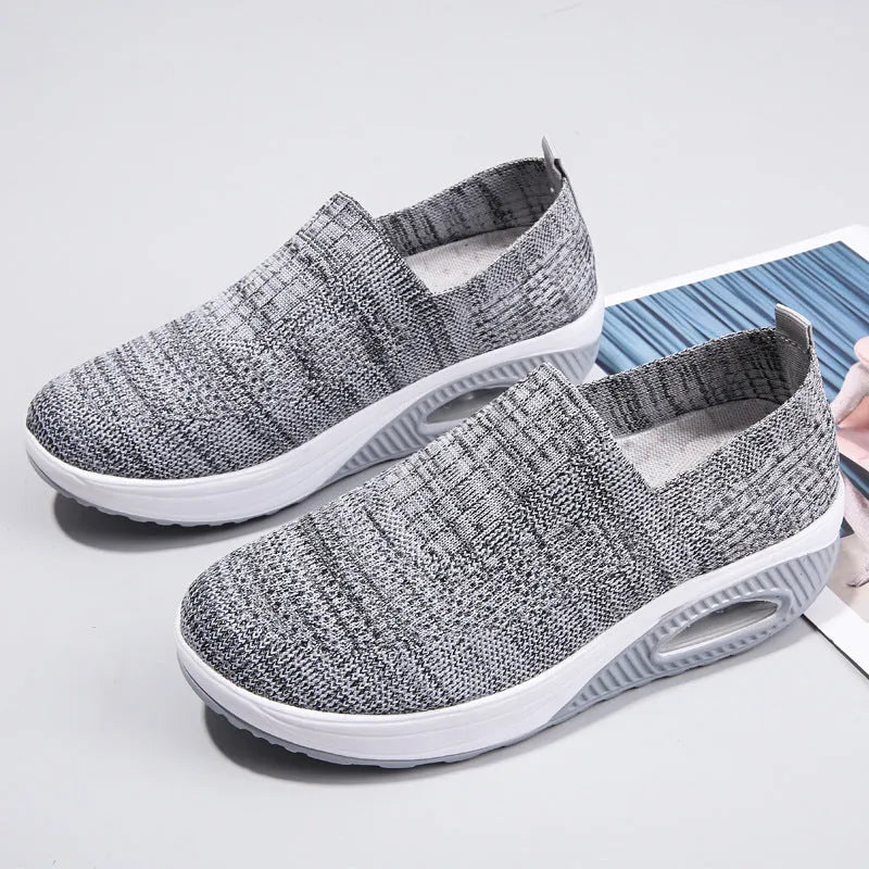 Women's beige mesh running shoes with round toe and air cushion midsole on a grey background.