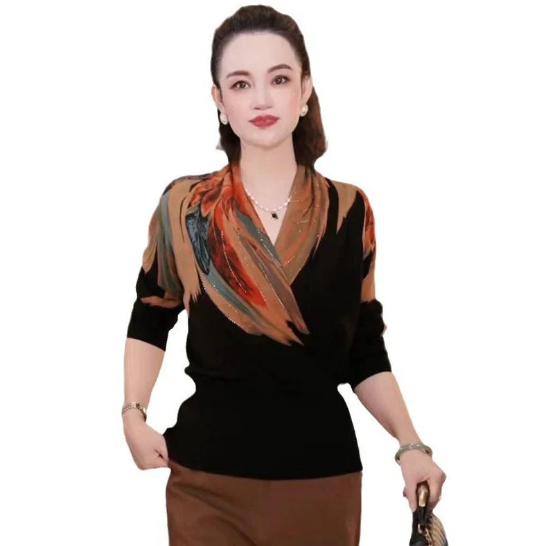 Black geometric floral pattern V-neck sweater with long sleeves and loose fit on hanger