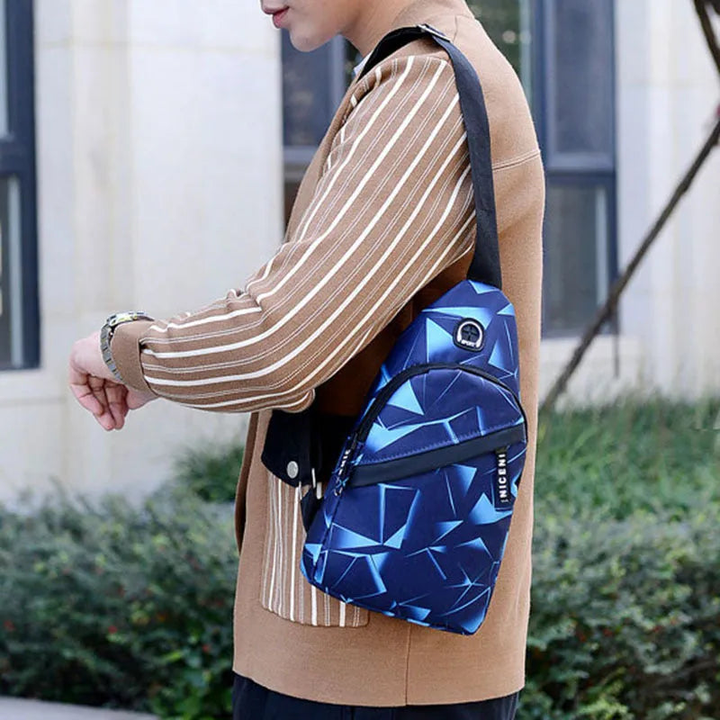 Men's sling chest bag in blue with earphone hole, crossbody strap, and zipper pockets, measuring 17cm wide.