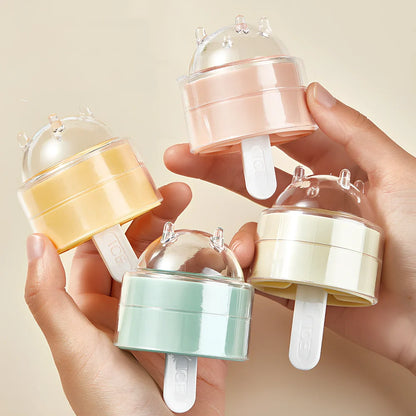 Four colourful lollipop-shaped silicone ice moulds showing creamy yellow, pink, blue, and yellow options