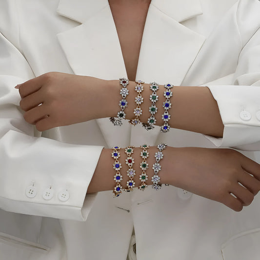 Floral shaped zinc alloy bracelet with electroplated colourful gem finishes in gold and silver tones.