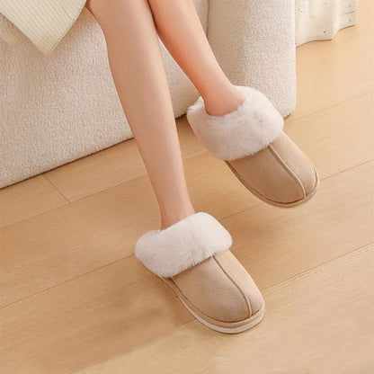 Women's plush indoor slippers in a selection of colours with a fuzzy upper and flat sole.