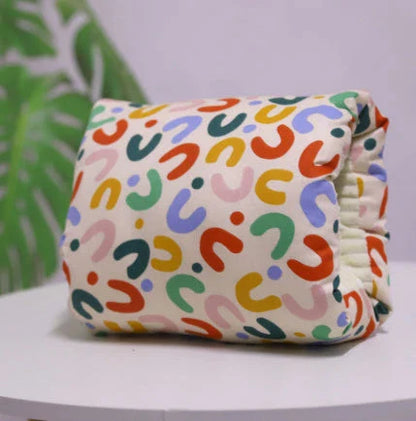 Adjustable cotton nursing pillow with various colorful designs, providing comfort and support for breastfeeding and bottle-feeding