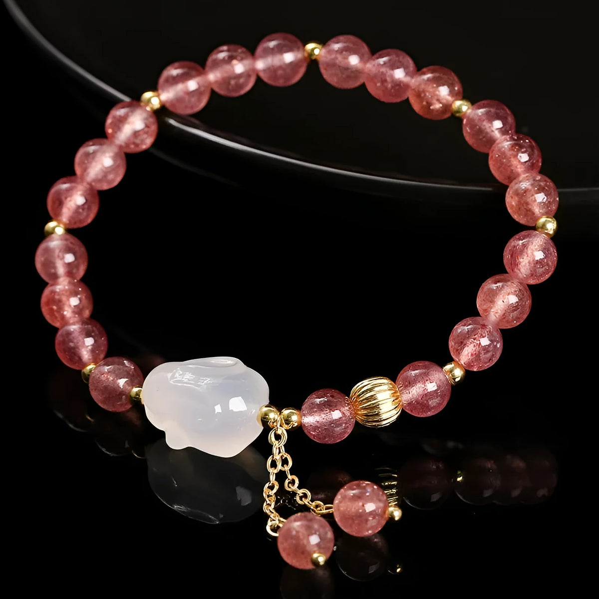 Women's strawberry quartz agate bracelet with 6mm round beads and white rabbit charm.