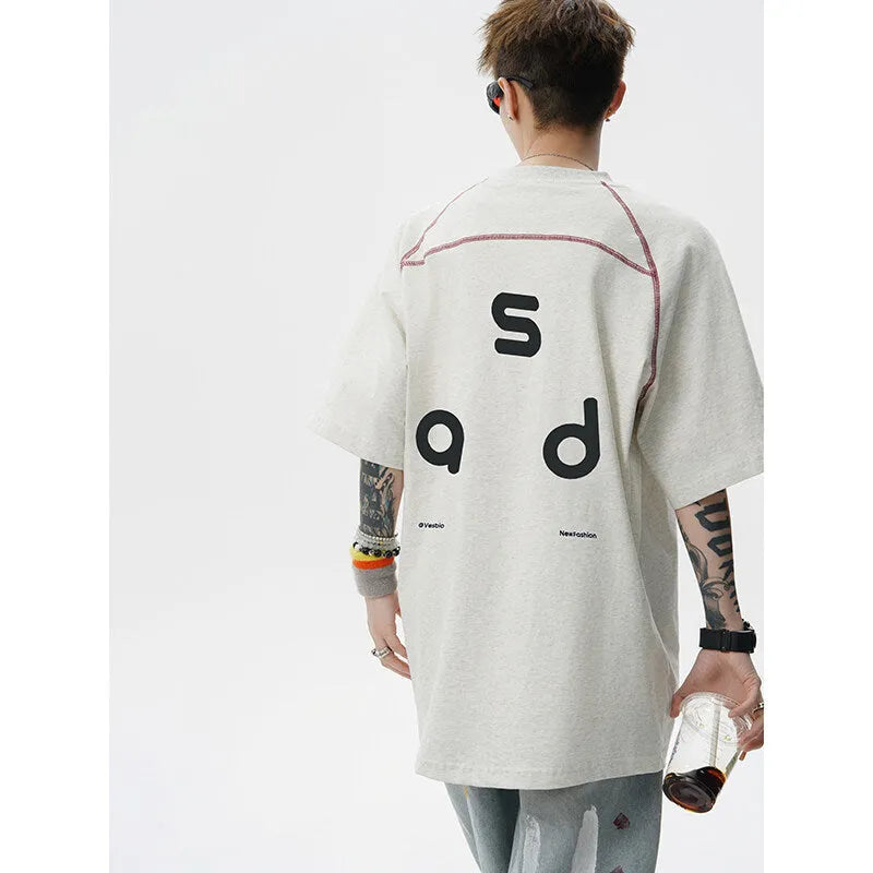 Black loose fit cotton T-shirt with white letter print on front, short sleeves and round neck.