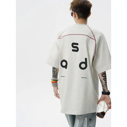 Black loose fit cotton T-shirt with white letter print on front, short sleeves and round neck.